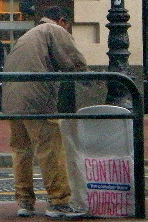 Saw this man scrounging for stuff to place in his Container Store sack from inside a Starbucks.
