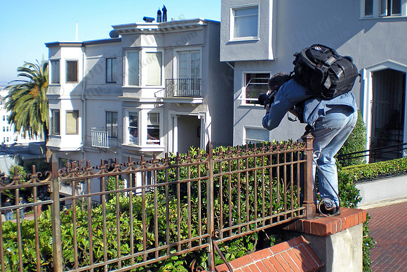 Some guy taking photos from the top of Lombard Street.