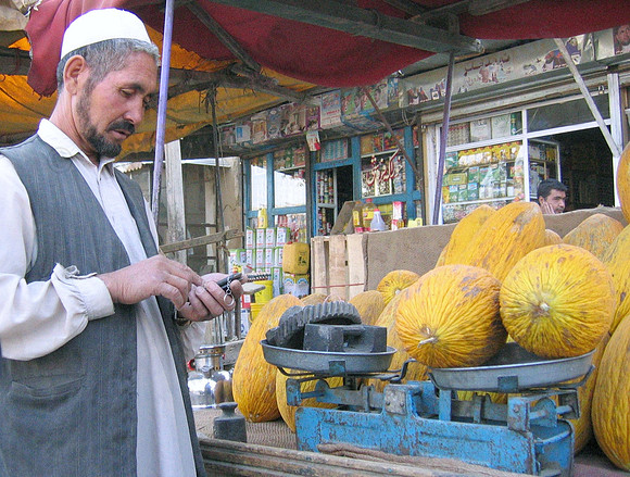 Kabul merchant at street bazaar, gotta love the counter weights!